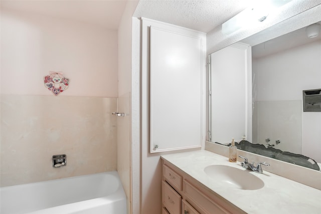 bathroom with vanity, a textured ceiling, and a wall unit AC