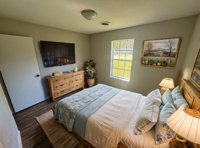 bedroom with dark hardwood / wood-style floors