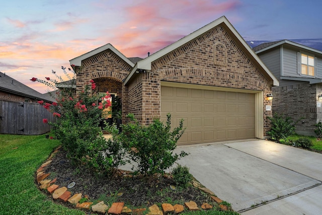 view of front of house featuring a garage and a yard