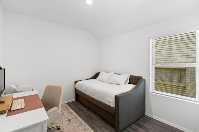 bedroom featuring multiple windows, lofted ceiling, and dark hardwood / wood-style floors