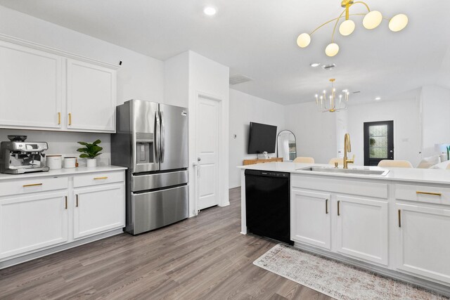 kitchen featuring light hardwood / wood-style floors, stainless steel refrigerator with ice dispenser, pendant lighting, sink, and dishwasher