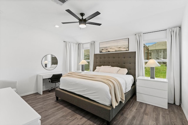 bedroom with multiple windows, dark wood-type flooring, and ceiling fan