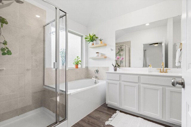 bathroom with separate shower and tub, vanity, and hardwood / wood-style flooring