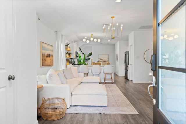 living room featuring dark hardwood / wood-style flooring and an inviting chandelier