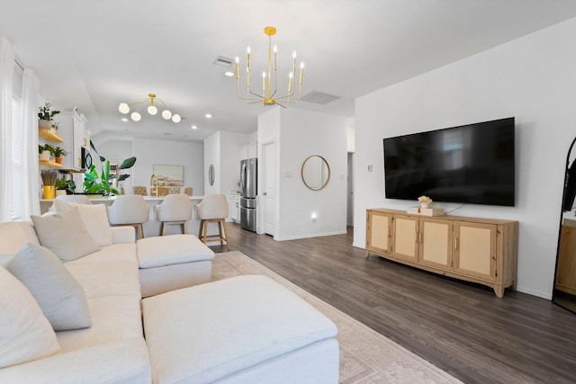 living room featuring dark hardwood / wood-style flooring, a notable chandelier, and sink