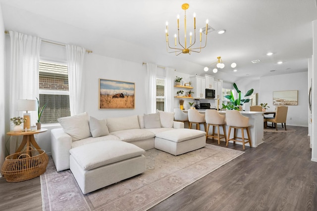 living room featuring wood-type flooring and a chandelier