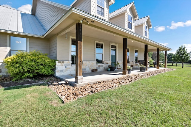 exterior space with covered porch and a front yard