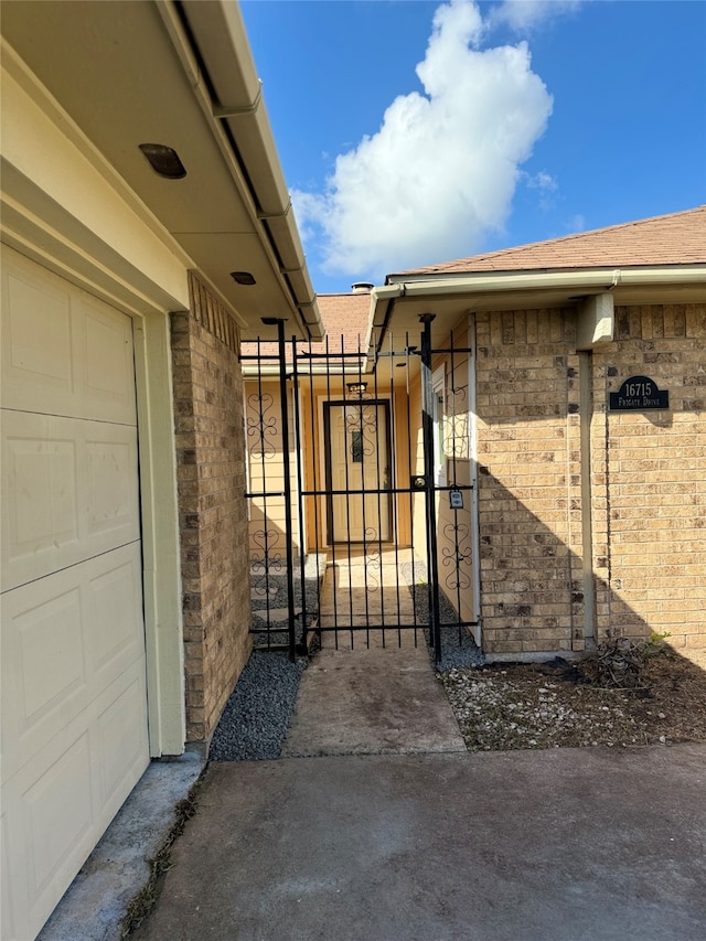 view of gate with a garage