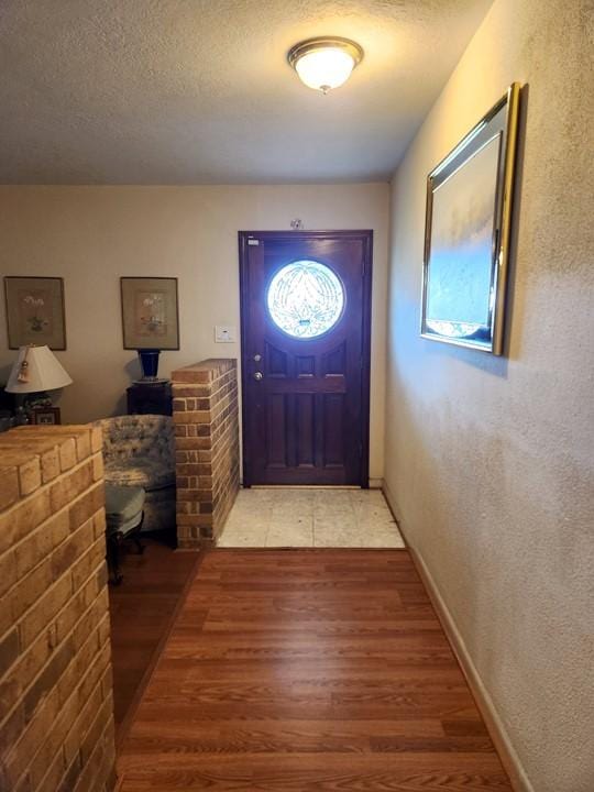 entryway featuring a textured ceiling and hardwood / wood-style flooring