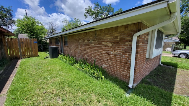 view of property exterior featuring a lawn and central AC unit