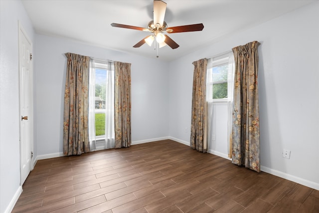 unfurnished room featuring dark hardwood / wood-style floors, plenty of natural light, and ceiling fan