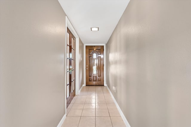 doorway to outside featuring light tile patterned floors