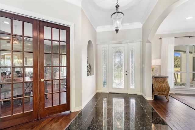 entryway with french doors, crown molding, and plenty of natural light