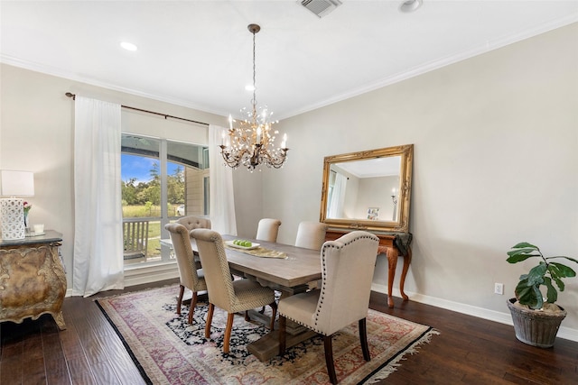 dining room featuring dark wood-type flooring, crown molding, and a chandelier