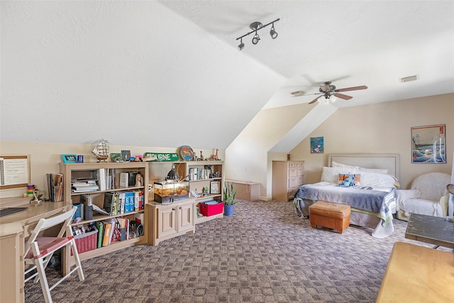 carpeted bedroom with vaulted ceiling, a textured ceiling, and ceiling fan