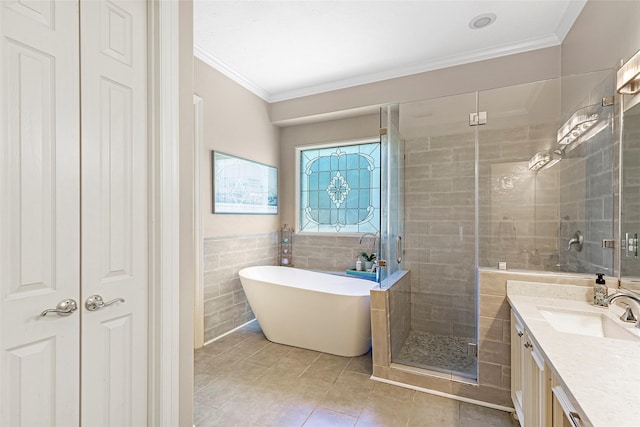 bathroom with vanity, tile walls, ornamental molding, and independent shower and bath