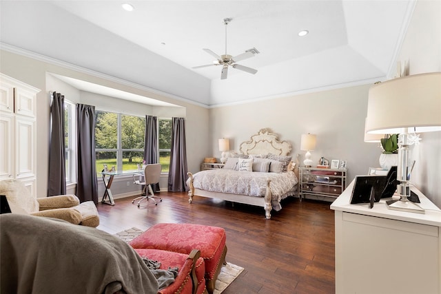 bedroom with a raised ceiling, ceiling fan, ornamental molding, and dark wood-type flooring