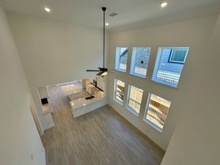 unfurnished living room featuring ceiling fan and light hardwood / wood-style floors