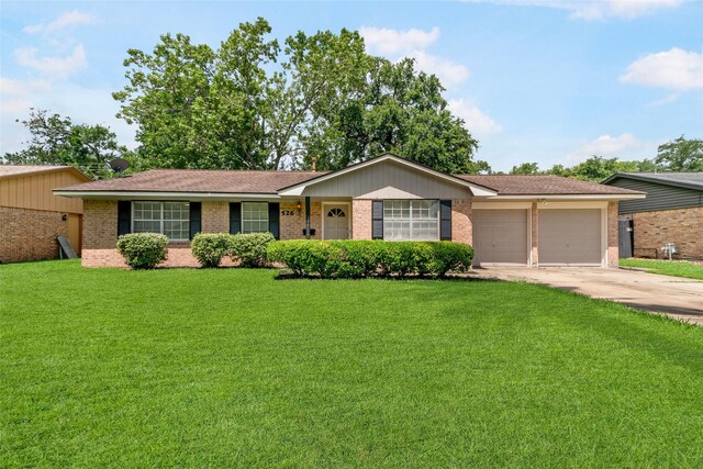 ranch-style home with a garage and a front lawn