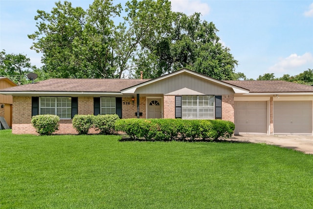 ranch-style house featuring a front lawn and a garage