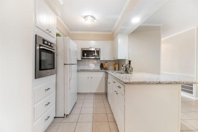 kitchen with kitchen peninsula, white cabinets, and stainless steel appliances