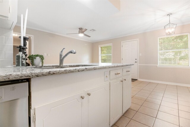 kitchen featuring light tile patterned floors, white cabinetry, stainless steel dishwasher, crown molding, and sink