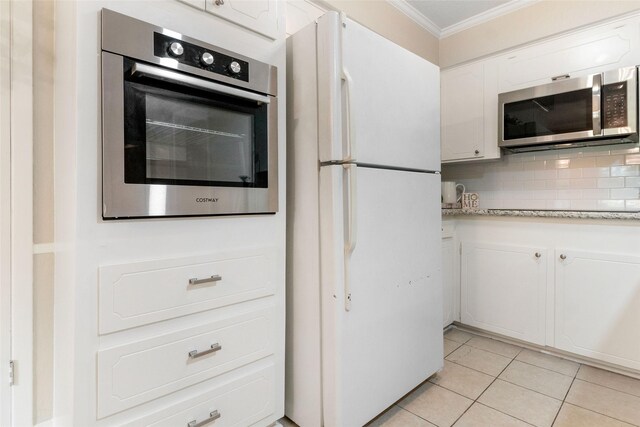 kitchen featuring white cabinetry, backsplash, appliances with stainless steel finishes, and ornamental molding