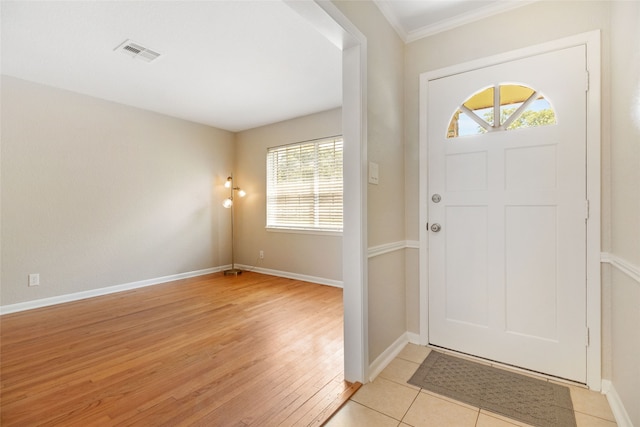 entrance foyer with crown molding, light hardwood / wood-style floors, and plenty of natural light