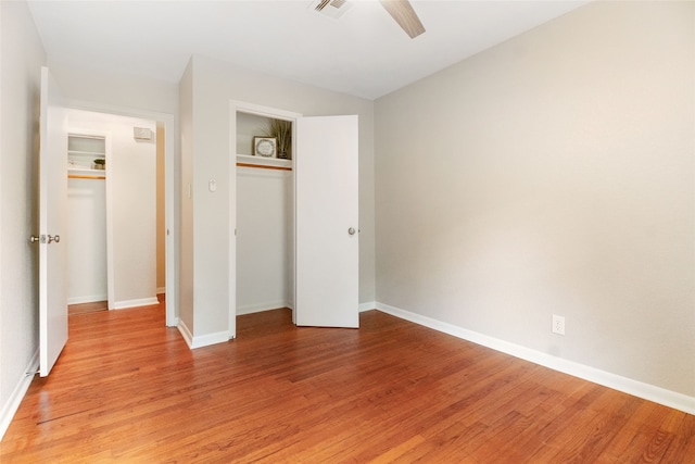 unfurnished bedroom with a closet, light wood-type flooring, and ceiling fan