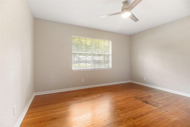 spare room featuring hardwood / wood-style floors and ceiling fan