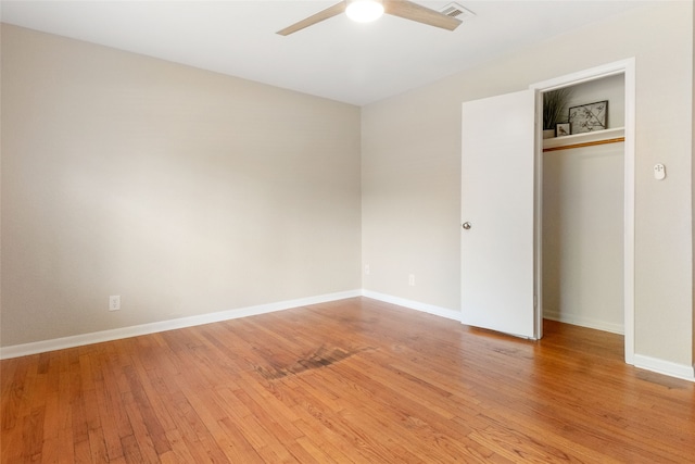 unfurnished bedroom featuring light hardwood / wood-style flooring, a closet, and ceiling fan