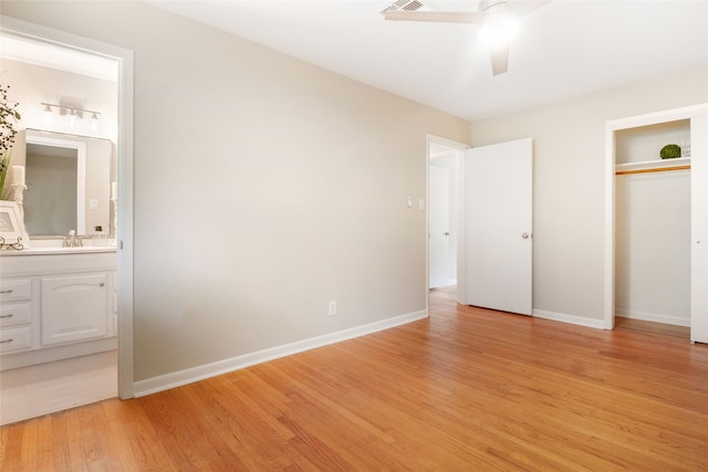 unfurnished bedroom with ensuite bath, light hardwood / wood-style flooring, and ceiling fan