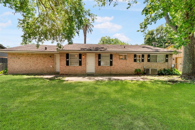 back of house with central AC and a lawn