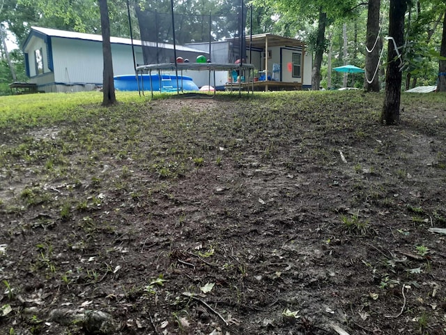 view of yard with a trampoline