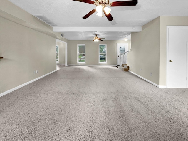 carpeted empty room with ceiling fan and a textured ceiling