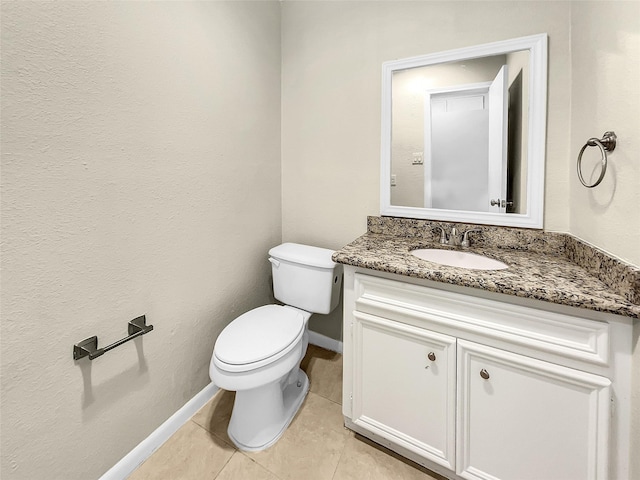 bathroom with tile patterned floors, vanity, and toilet