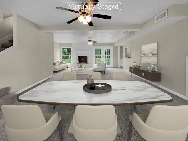 dining area featuring ceiling fan, beam ceiling, and carpet floors