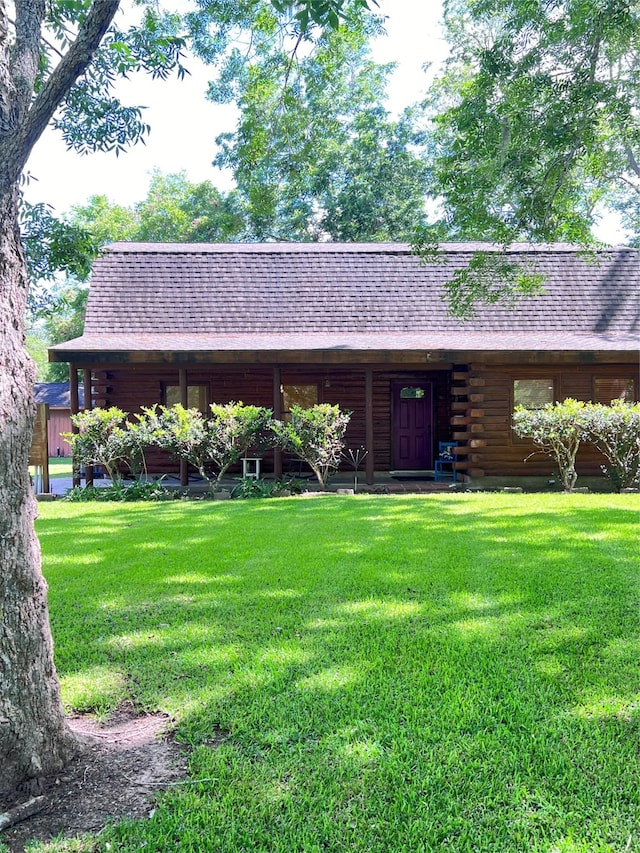 cabin with a front lawn