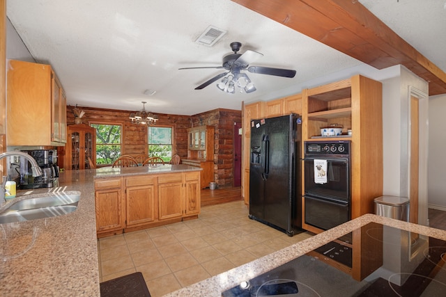 kitchen featuring kitchen peninsula, light tile patterned floors, black appliances, ceiling fan with notable chandelier, and sink