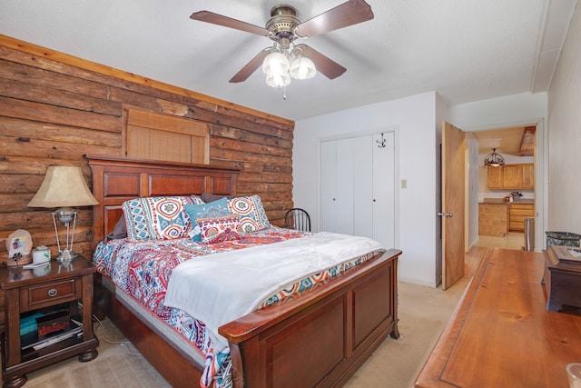 carpeted bedroom featuring a closet, a textured ceiling, and ceiling fan