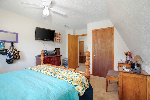 bedroom with ceiling fan, a textured ceiling, and carpet floors