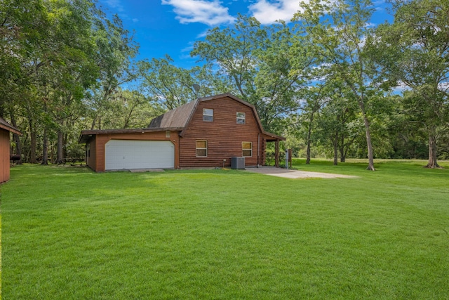 view of home's exterior featuring a yard, a garage, and central AC unit