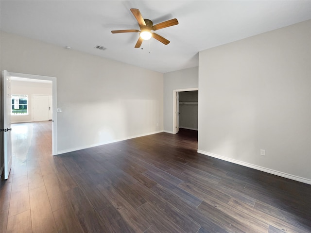 spare room featuring dark hardwood / wood-style flooring and ceiling fan