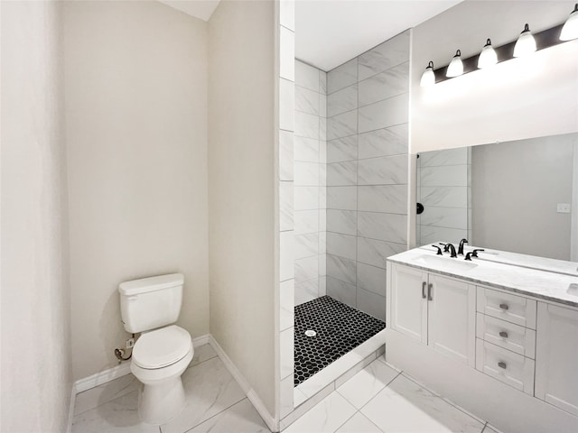 bathroom with tile patterned flooring, toilet, vanity, and a tile shower