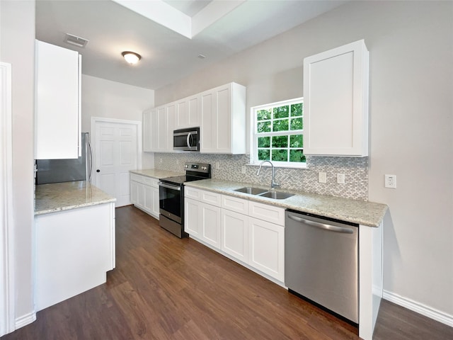 kitchen featuring white cabinetry, dark hardwood / wood-style flooring, decorative backsplash, sink, and appliances with stainless steel finishes