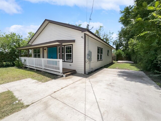 view of home's exterior featuring a lawn and covered porch