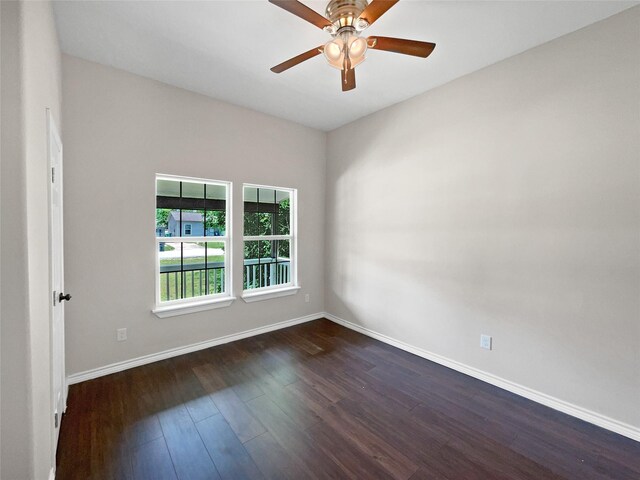 empty room with dark hardwood / wood-style floors and ceiling fan