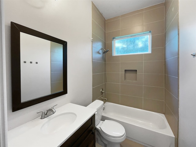 full bathroom featuring vanity, tiled shower / bath combo, and toilet