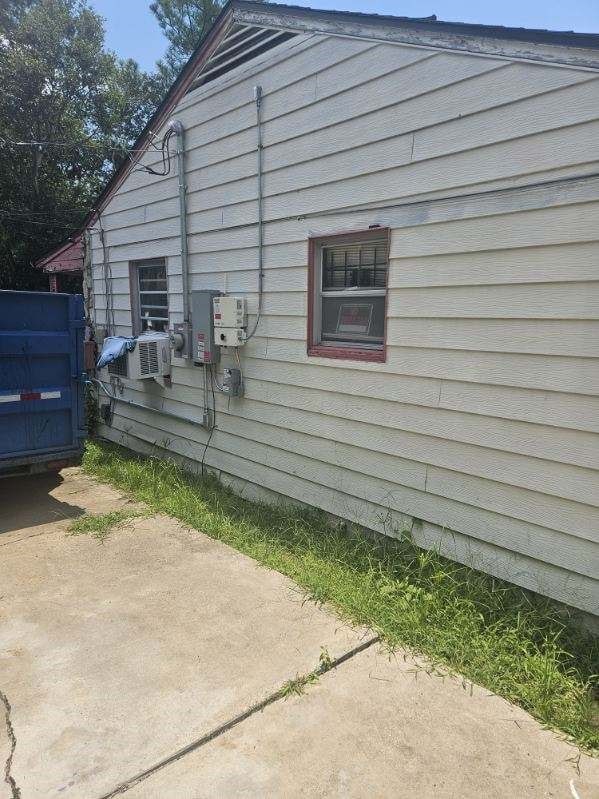 view of side of property with a patio area