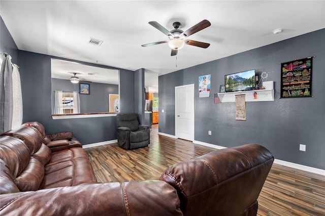 living room with dark hardwood / wood-style flooring and ceiling fan